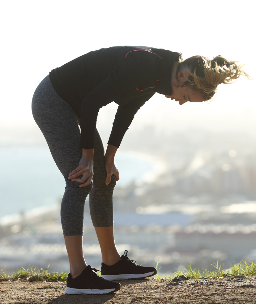 Photo of a woman feeling dehydrated during a run